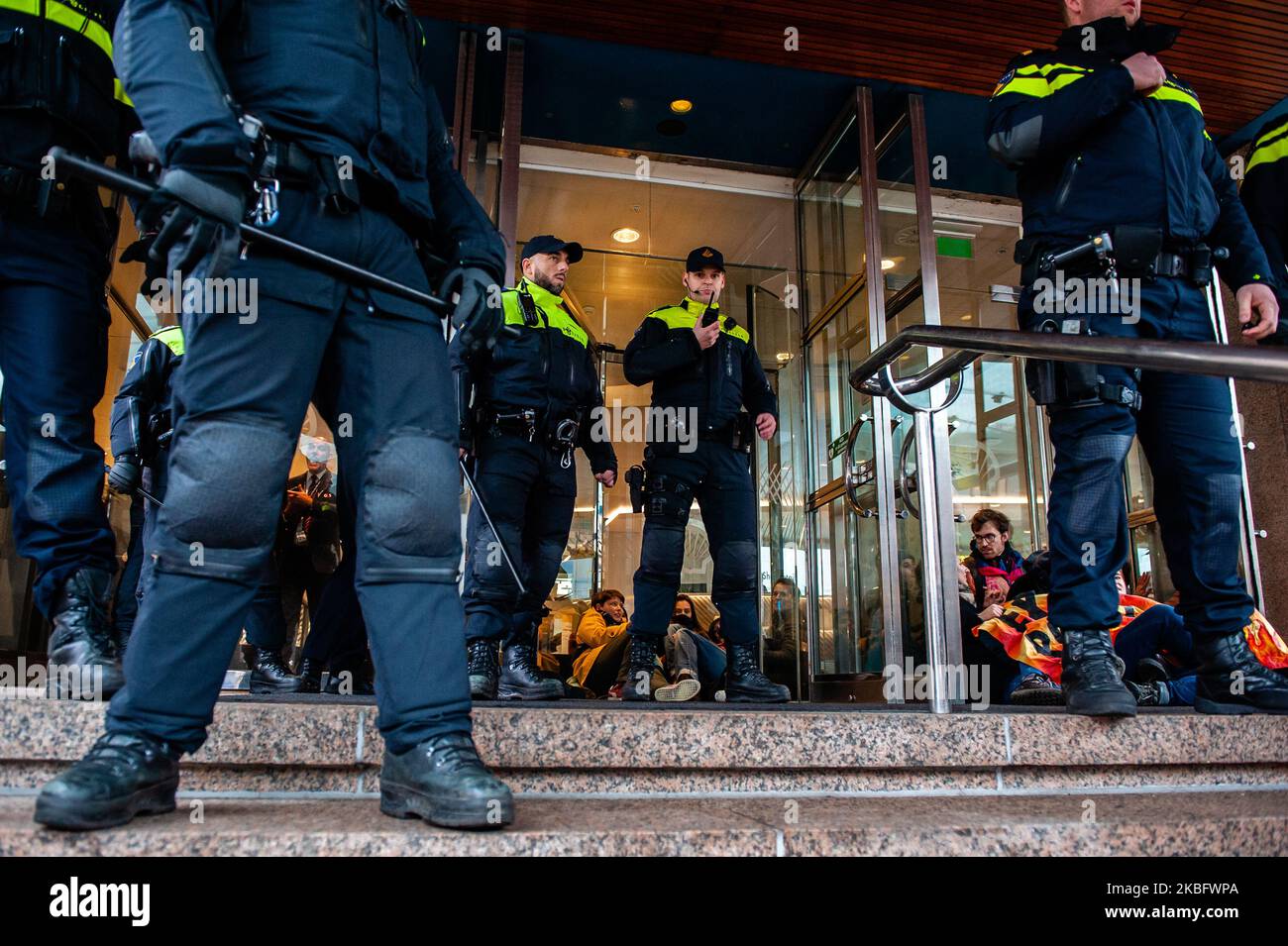 Les militants XR sont collés aux portes en cristal du siège de Shell, à la Haye, lors d'une action contre la compagnie pétrolière, sur 31 janvier 2020. (Photo par Romy Arroyo Fernandez/NurPhoto) Banque D'Images