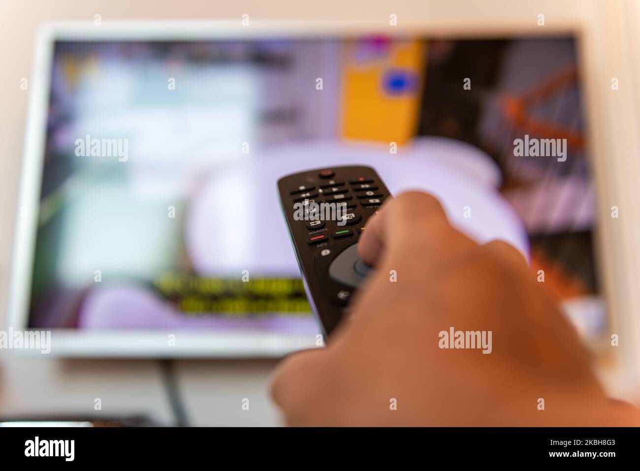 Personne utilisant la télécommande d'un téléviseur. Banque D'Images