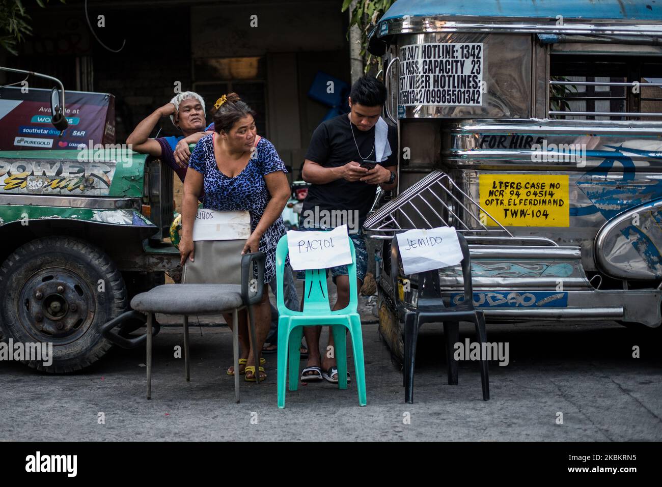 Les résidents ont placé des chaises portant leur nom le long de la rue pour servir de points de dépôt pour les produits de secours à Quezon City, Philippines sur 30 mars 2020. L'île de Luzon, qui comprend le métro de Manille, est placée sous une « quarantaine communautaire renforcée » dans un effort pour freiner la propagation de la COVID-19. Les cours, le travail et le transport de masse sont suspendus dans toute l'île avec quelques exemptions.(photo de Lisa Marie David/NurPhoto) Banque D'Images