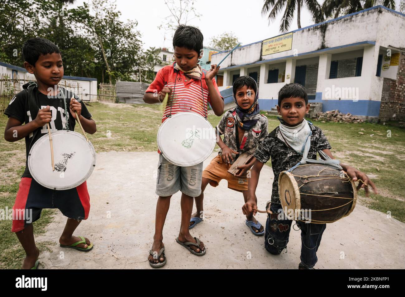 Un groupe d'enfants chantant et jouant des tambours sur un terrain sans sécurité Corona à Tehatta, Bengale-Occidental, Inde, on 23 mars 2020. La plupart de leurs pères ou de leur mère travaillent dans d'autres États. Le problème avec les villages éloignés comme Tehatta est que toutes les nouvelles arrivent tard.le gouvernement du Bengale occidental a identifié sept de ses zones comme ''hotspots' de l'infection du virus Corona et Tehatta, Bengale occidental, est l'un d'eux. (Photo de Soumyabrata Roy/NurPhoto) Banque D'Images