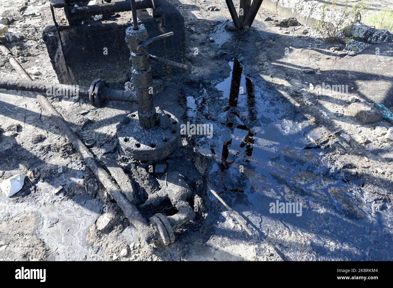 ALBANIE, Kuçova, nommé ville de Staline de 1950 to1991, champ de pétrole brut et pompe de forage de l'ère communiste, toujours en fonctionnement et polluant l'environnement, puddle de pétrole / ALBANIEN, Kucova, von 1950 bis 1991 Qyteti Staline, Stalinstadt, Erdoelfoerderung, alte Oelfoerderpumpe, die heute noch, Özür Betrieb, Ölzur Betriderung, Ölache Betriffung Banque D'Images