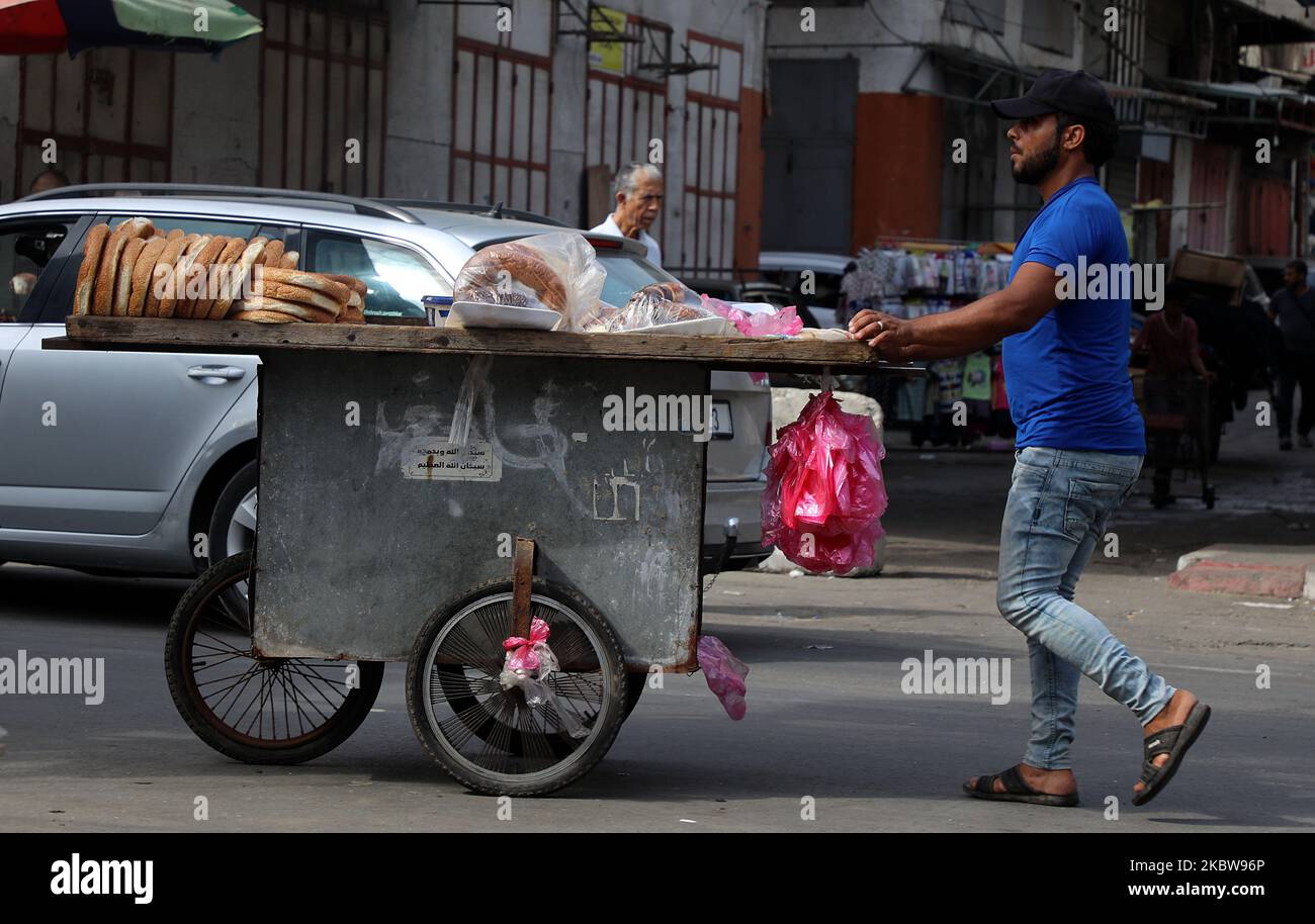 Un vendeur palestinien pousse une voiturette avec du pain lors d'une journée chaude à Gaza, le 27 juillet 2020. (Photo de Majdi Fathi/NurPhoto) Banque D'Images