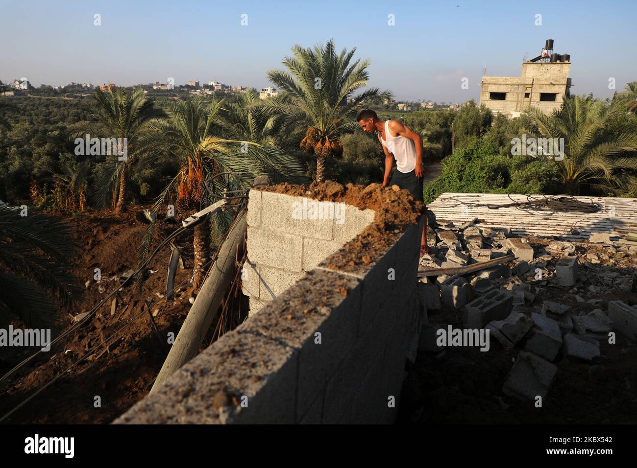 Un homme palestinien inspecte les décombres, les débris et autres dommages sur un toit à la suite d'une attaque aérienne israélienne, à l'est du camp d'al-Bureij, à l'intention des réfugiés palestiniens dans le centre de la bande de Gaza, à 15 août 2020. (Photo de Majdi Fathi/NurPhoto) Banque D'Images