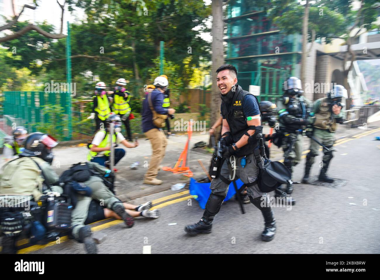 Un policier, avec son fusil tiré, émet des avertissements à l'encontre des manifestants qui propulse des cocktails molotov et des rochers vers l'équipe arrêtée alors qu'ils emprisonnent les manifestants. À Wong Tai Sin, Hong Kong, Chine, sur 1 octobre 2019. (Photo de Marc Fernandes/NurPhoto) Banque D'Images