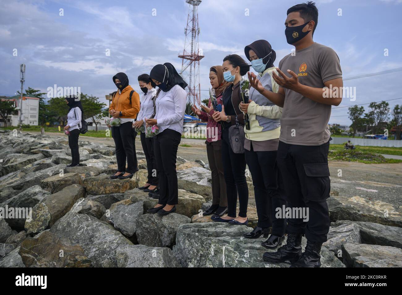 Les familles des victimes de catastrophes prient avant de semer des fleurs sur le site de l'ancien tsunami sur la plage de Taliise, à Palu, dans la province centrale de Sulawesi, en Indonésie, à 28 septembre 2020. Les fleurs sont semées pour prier et se souvenir de leurs familles qui ont été victimes du tsunami sur 28 septembre 2018 ou exactement deux ans auparavant. La catastrophe qui a été précédée d'un tremblement de terre de 7,4 sur l'échelle de Richter, a également été suivie par une liquéfaction à plusieurs points et a entraîné la mort de plus de 5 000 personnes et la détérioration de plus de 100 000 maisons. (Photo de Basri Marzuki/NurPhoto) Banque D'Images