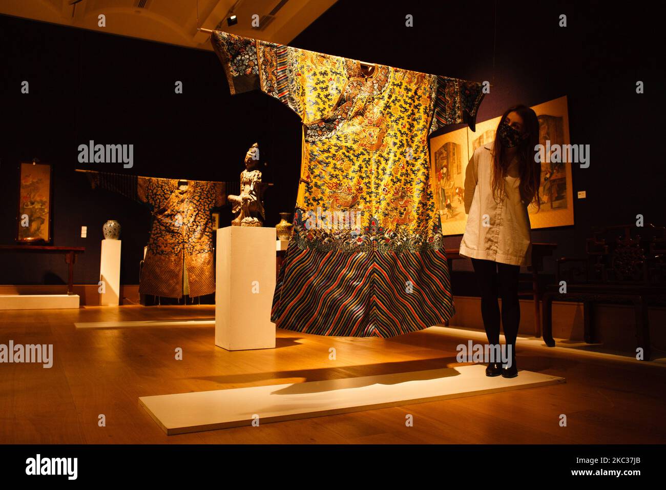 Un membre du personnel pose avec une rare robe de dragon chinoise de broderie impériale du 19th siècle (environ GBP40 000-60 000) lors d'un photocall pour les ventes de la semaine de l'art asiatique à la maison de vente aux enchères Bonhams sur New Bond Street à Londres, en Angleterre, sur 2 novembre 2020. La vente a lieu sur 5 novembre. (Photo de David Cliff/NurPhoto) Banque D'Images