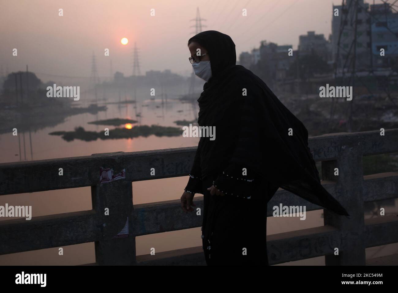 Une femme porte un masque pour prévenir le coronavirus Covid-19 lorsqu'elle se rend sur son lieu de travail tôt le matin dans la région de Keraniganj à Dhaka, au Bangladesh, mercredi, à 02 décembre 2020. (Photo de Syed Mahamudur Rahman/NurPhoto) Banque D'Images Une femme porte un masque pour prévenir le coronavirus Covid-19 lorsqu'elle se rend sur son lieu de travail tôt le matin dans la région de Keraniganj à Dhaka, au Bangladesh, mercredi, à 02 décembre 2020. (Photo de Syed Mahamudur Rahman/NurPhoto) Banque D'Images