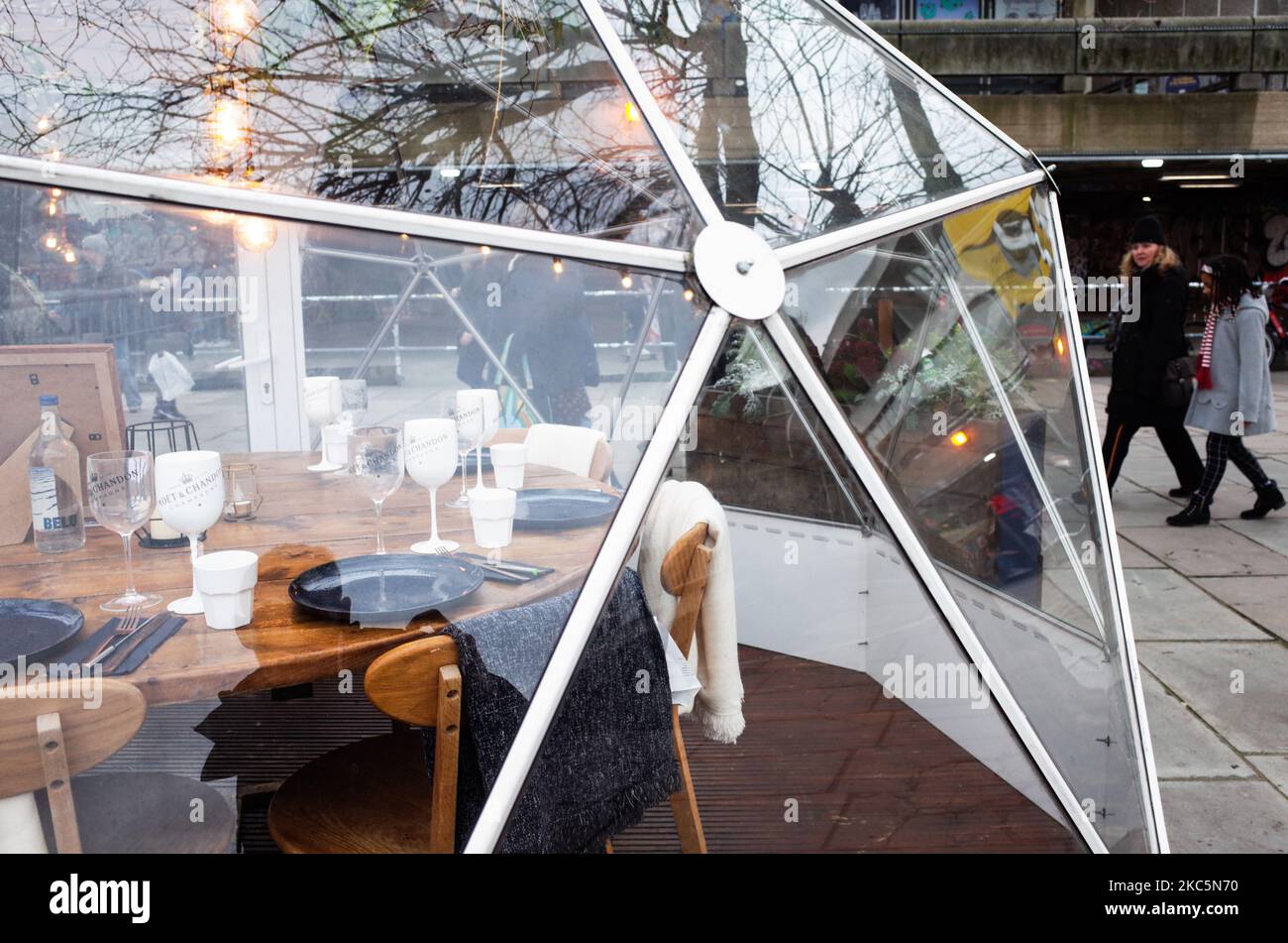 Les gens marchent devant un groupe de restaurants pop-up sur la rive sud de la Tamise à Londres, Angleterre, sur 12 décembre 2020. Les spéculations à Londres pourraient sans doute être soumises aux restrictions du coronavirus « Tier 3 » ont augmenté cette semaine, alors que le nombre de personnes se trouvant dans la ville pour le covid-19 était en hausse. Dans le cadre de la catégorie 3, les activités d'accueil seraient à nouveau forcées de fermer, à l'exception des activités à emporter, quelques semaines seulement après qu'elles aient été autorisées à rouvrir à la fin du deuxième confinement national sur 2 décembre. La décision sera prise ce mercredi, lors d'une réunion qui serait présidée par Brit Banque D'Images