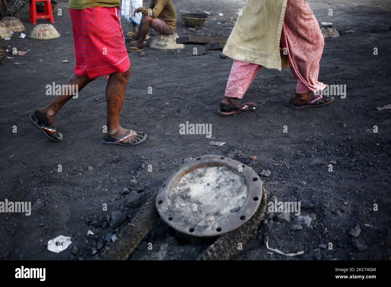 Les travailleurs transportent du charbon sur des paniers lorsqu'ils déchargent ces produits d'un cargo sur la rive du fleuve Buriganga à Dhaka, au Bangladesh, vendredi, au 08 janvier 2021. La consommation actuelle de charbon pour la production d'électricité est d'environ 3,5 millions de tonnes par an pour les deux centrales à charbon du Bangladesh, l'une à Barapukuria (440MW) à Dinajpur et l'autre est la nouvelle centrale Payra (660MW) à Patuakhali. Selon le rapport des médias, si le Plan directeur du secteur de l'énergie 2016 est mis en œuvre, la consommation de charbon pour la production d'électricité serait 10 fois plus en 2030 et 20 fois plus en 2041 que le rp Banque D'Images Les travailleurs transportent du charbon sur des paniers lorsqu'ils déchargent ces produits d'un cargo sur la rive du fleuve Buriganga à Dhaka, au Bangladesh, vendredi, au 08 janvier 2021. La consommation actuelle de charbon pour la production d'électricité est d'environ 3,5 millions de tonnes par an pour les deux centrales à charbon du Bangladesh, l'une à Barapukuria (440MW) à Dinajpur et l'autre est la nouvelle centrale Payra (660MW) à Patuakhali. Selon le rapport des médias, si le Plan directeur du secteur de l'énergie 2016 est mis en œuvre, la consommation de charbon pour la production d'électricité serait 10 fois plus en 2030 et 20 fois plus en 2041 que le rp Banque D'Images