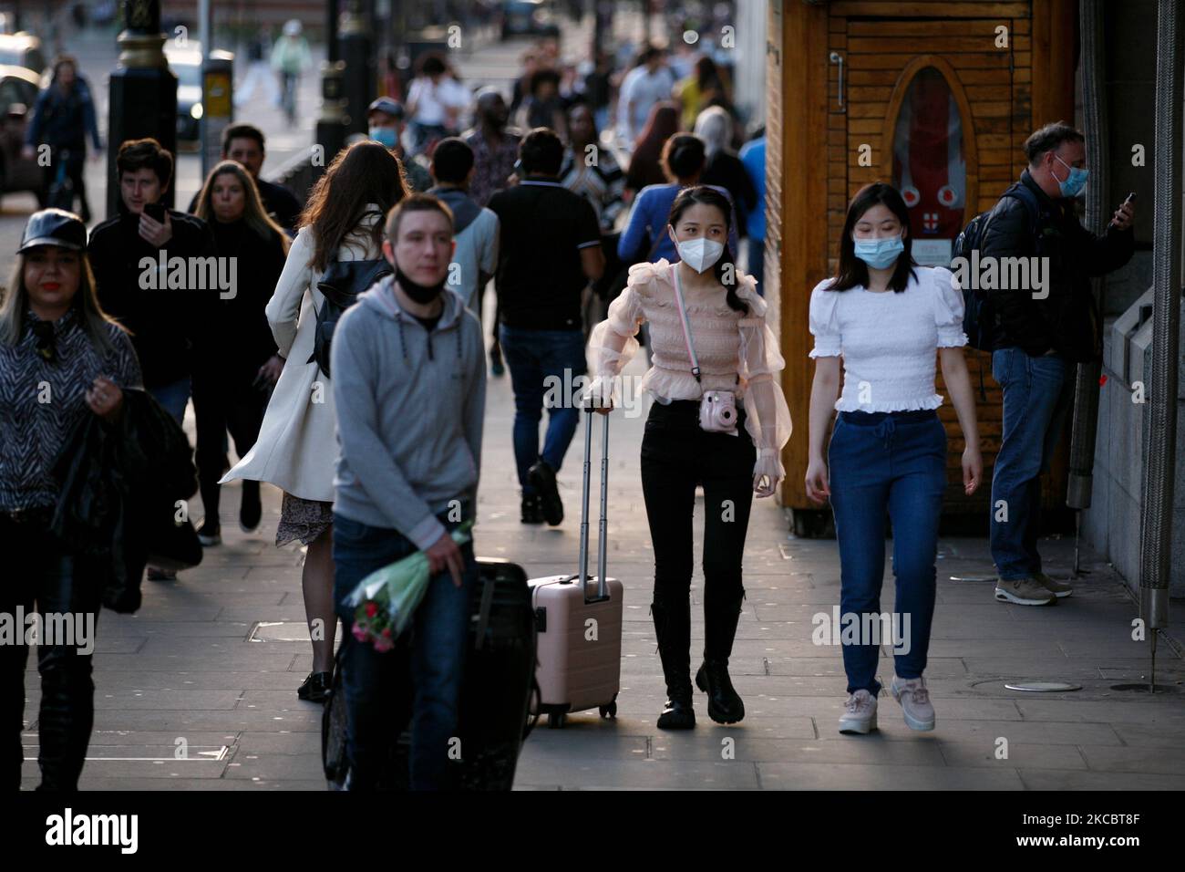 Les femmes portant des masques de visage marchent le long d'une rue animée de Bridge à l'extérieur de la gare de Westminster alors que le crépuscule tombe à la fin d'une chaude journée de printemps à Londres, en Angleterre, sur 30 mars 2021. Hier, les restrictions relatives au verrouillage des coronavirus ont été assouplies dans toute l'Angleterre, la règle de la « maison isolée » ayant pris fin, les groupes de six personnes ont été autorisés à se réunir à l'extérieur, les sports en plein air ont repris et les mariages avec jusqu'à six personnes sont maintenant autorisés. Les magasins, l'hôtellerie et les loisirs restent fermés, mais la prochaine étape de l'assouplissement du confinement n'est pas prévue avant 12 avril au plus tôt. (Photo de David Cliff/NurPhoto) Banque D'Images