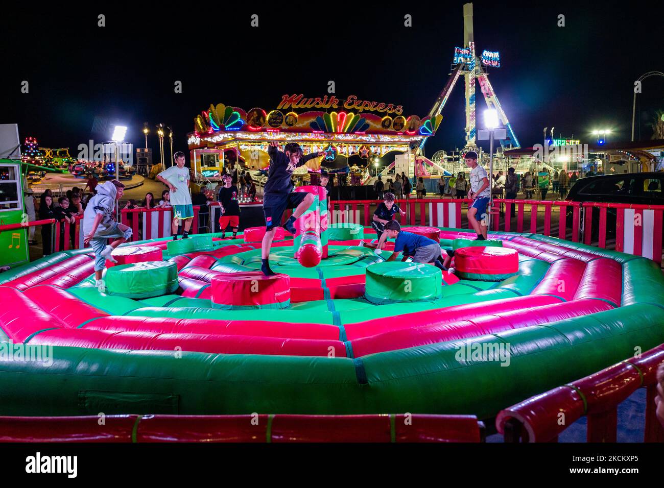 Les garçons ont du plaisir à sauter sur l'obstacle tournant le premier jour de l'ouverture du Luna Park à Molfetta le 4 septembre 2021. A l'occasion de la Fête Patronale de Molfetta et en l'honneur de la Madonna dei Martiri, le Luna Park a été ouvert à la Secca dei Pali, avec des portes d'accès et de sortie, le contrôle de la température d'accès et le contrôle aléatoire des passes vertes selon les instructions de la loi. (Photo par Davide Pischettola/NurPhoto) Banque D'Images