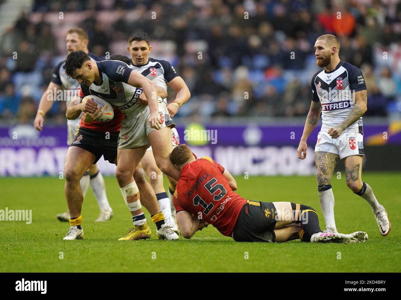 L'équipe d'Angleterre Herbie Farnworth (à gauche) est affrontée par Dan Russell (à droite) de Papouasie-Nouvelle-Guinée et Rhyse Martin lors du match de finale de la coupe du monde de rugby à XV au stade DW de Wigan. Date de la photo: Samedi 5 novembre 2022. Banque D'Images