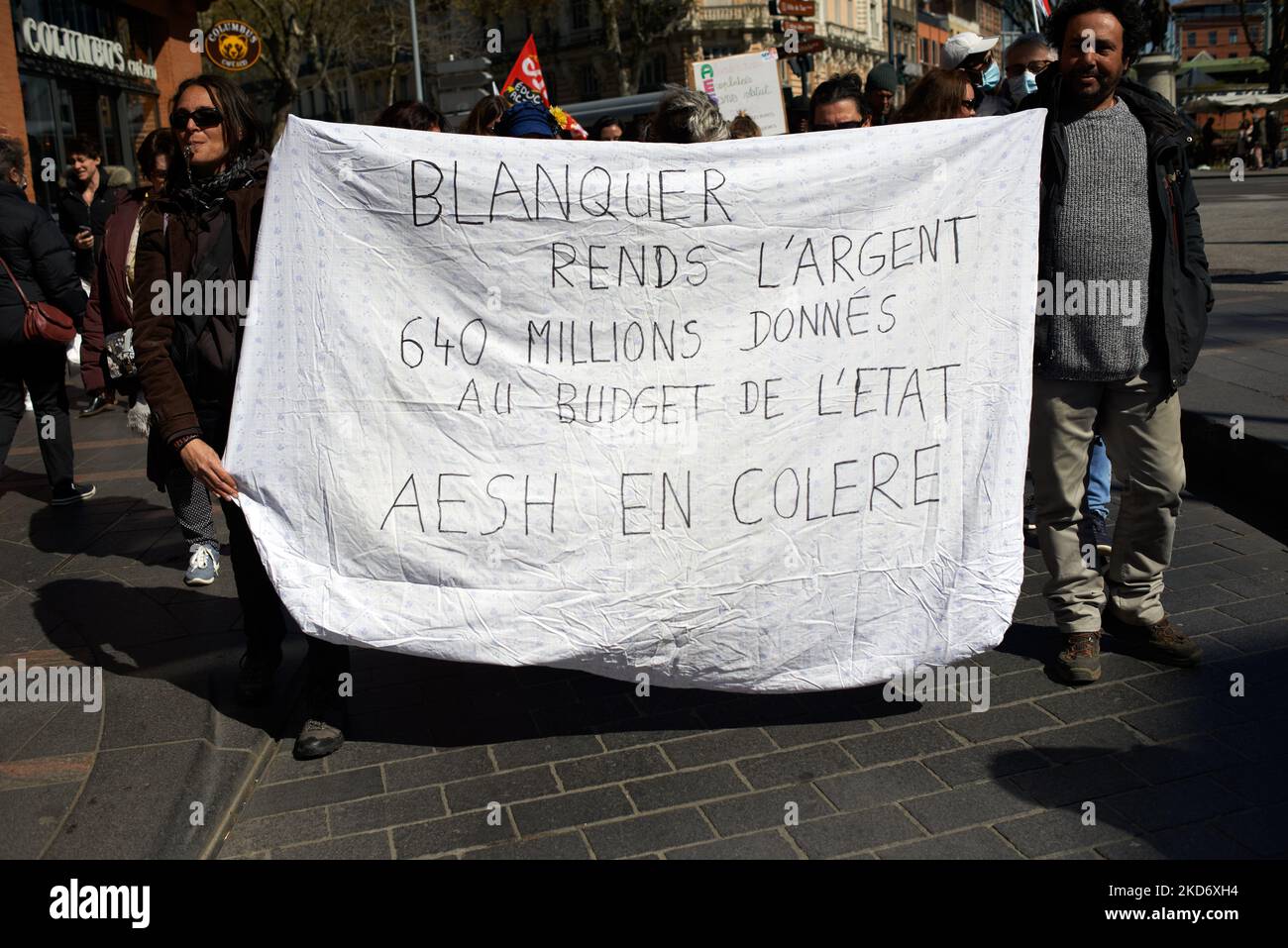 Deux manifestants tiennent un feuillet indiquant « Blanquer, remettre l'argent, 640m € étant donné le budget de l'État, Angry AESH ». A la suite d'un appel national à la grève et à la protestation, l'AESH ('accompagnant d'élève en situation de handicap') a protesté à Toulouse. L'acronyme AESH signifie « support Assistant for Disabled Epupilles ». Principalement des femmes travaillent comme AESH. Ils protestent principalement contre le manque de financement, les contrats de travail néfastes et la pénurie de personnel . Toulouse. France. 5 avril 2022. (Photo d'Alain Pitton/NurPhoto) Banque D'Images