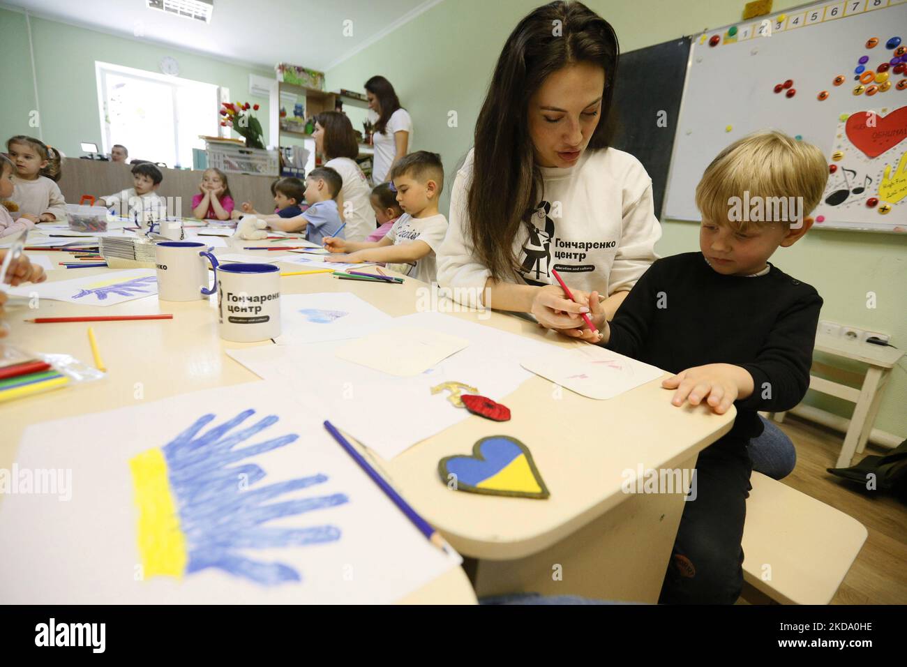 Enfants ukrainiens déplacés, des régions du pays les hostilités ont maintenant lieu, dessiner des photos pour faire des chevrons pour les uniformes des soldats ukrainiens, à Odesa, Ukraine 13 mai 2022. Les photos des enfants seront utilisées par les volontaires pour fabriquer des chevrons pour les uniformes des soldats ukrainiens. (Photo par STR/NurPhoto) Banque D'Images