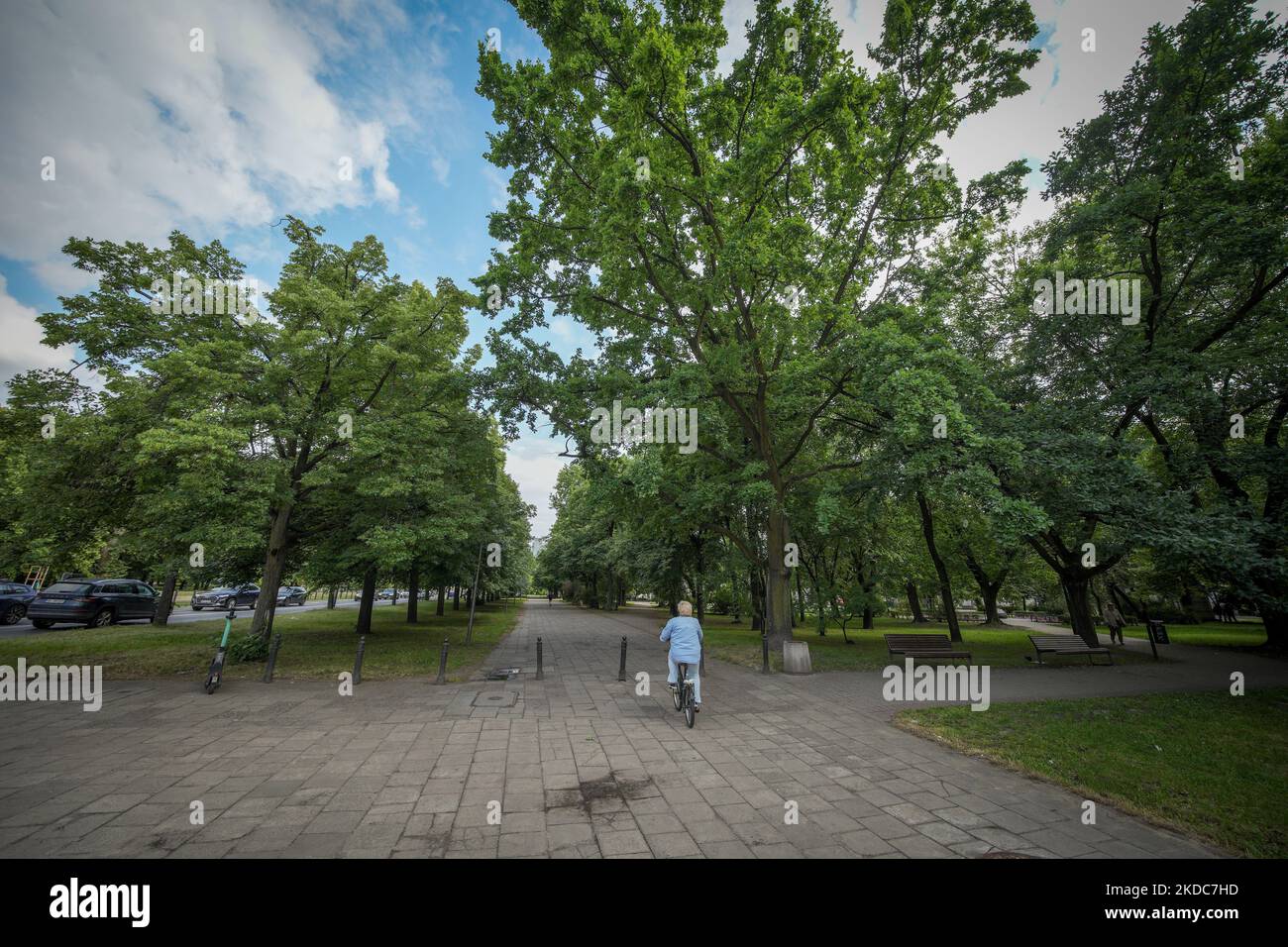 Le 14 juin 2022, une femme en chemise bleu clair fait des cycles sur un bicycle dans un petit parc à Varsovie, en Pologne. (Photo par STR/NurPhoto) Banque D'Images