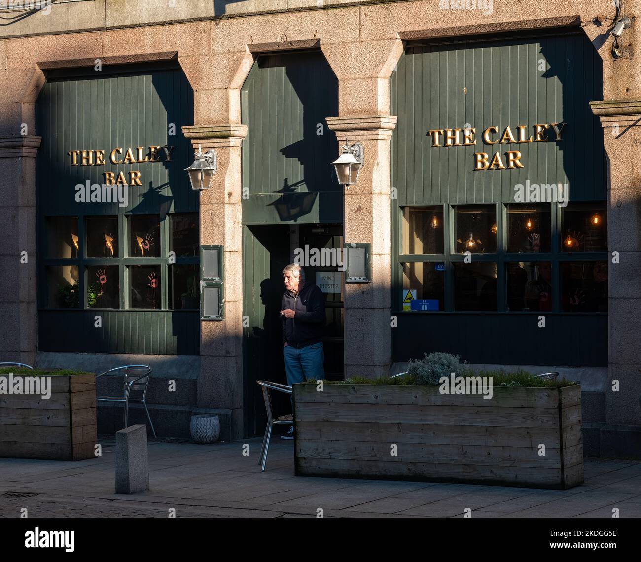 3 novembre 2022. Peterhead, Aberdeenshire, Écosse. C'est un homme qui fume à la porte d'entrée du bar Caley à Peterhead. Banque D'Images