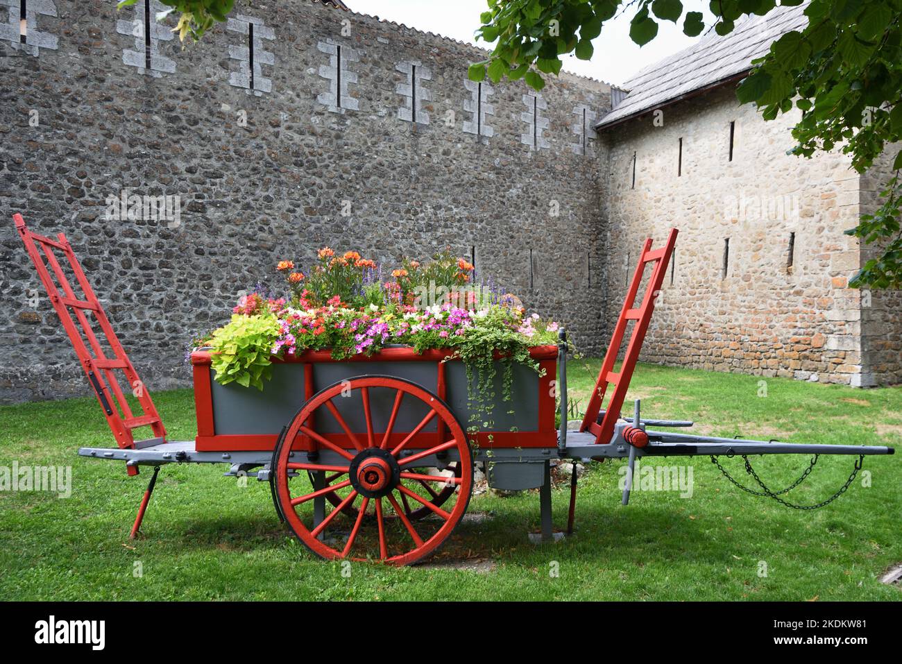 Ancien chariot de foin en bois ou chariot de ferme restauré, peint et utilisé comme jardinière de fleurs décoratives ou d'affichage de fleurs Colmars-les-Alpes Provence France Banque D'Images