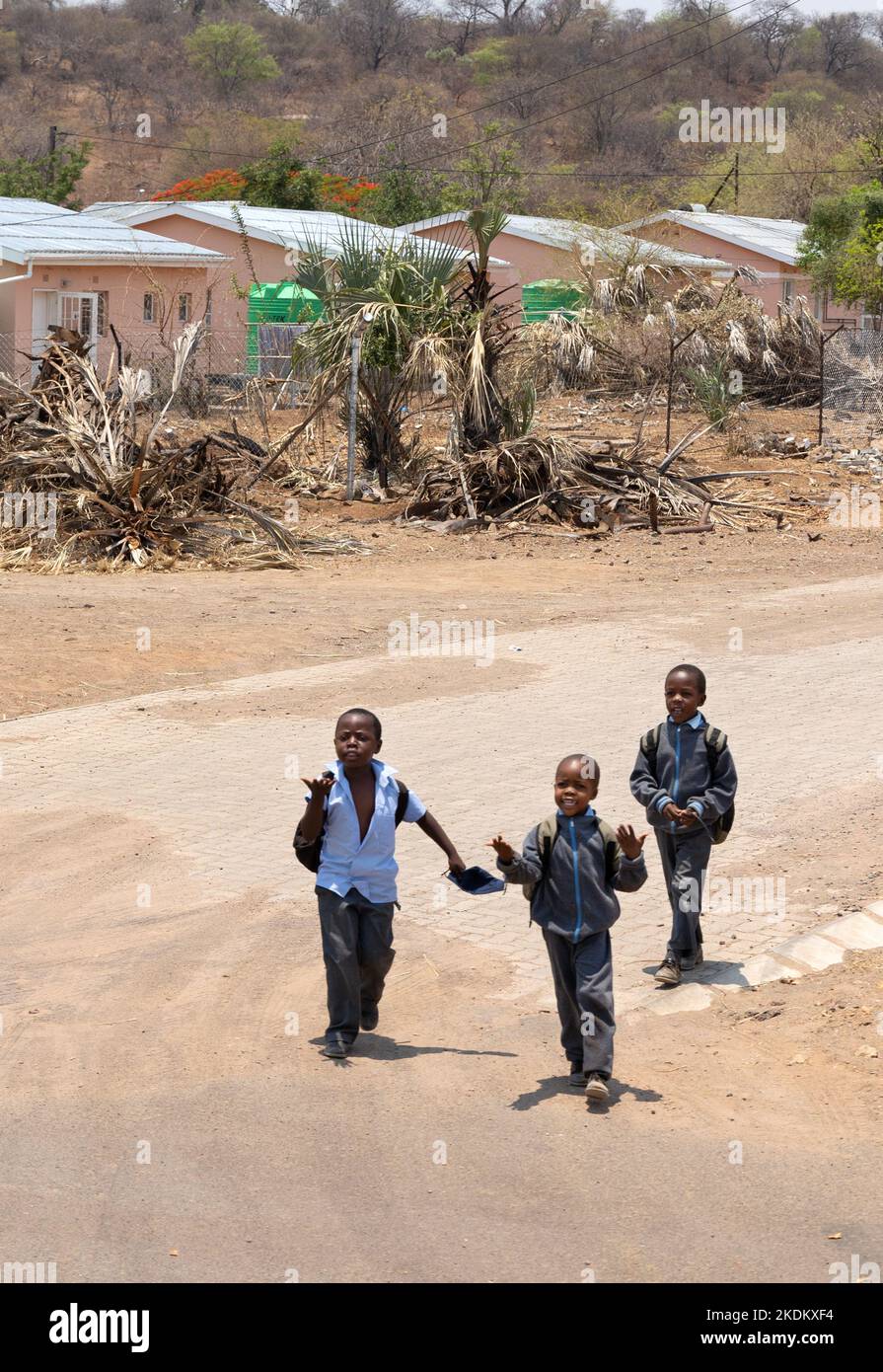 Enfants africains; trois jeunes garçons africains sur la route, ville de Kasane, Afrique du Botswana. Enfants africains âgés de 10 ans. Banque D'Images