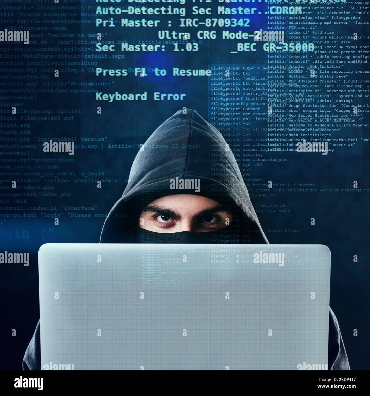Baiser vos mots de passe Au revoir. Portrait d'un pirate informatique à l'aide d'un ordinateur portable en se tenant sur un arrière-plan sombre. Banque D'Images
