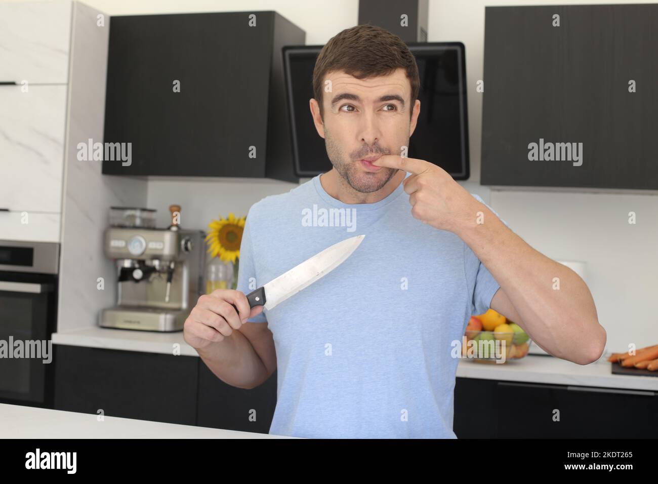 Homme ayant un petit accident dans la cuisine Banque D'Images
