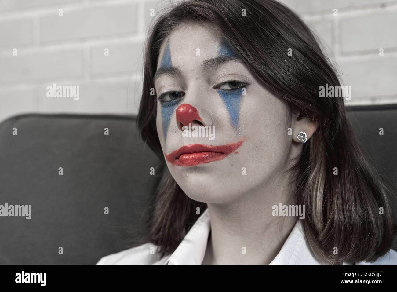 une adolescente avec le maquillage clown parle de quelque chose émotionnellement Banque D'Images