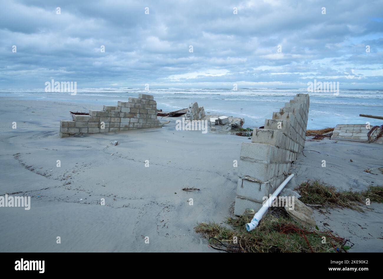 Les restes d'un mur de mer détruit par l'ouragan Nicole s'enfoncent dans le sable. Banque D'Images