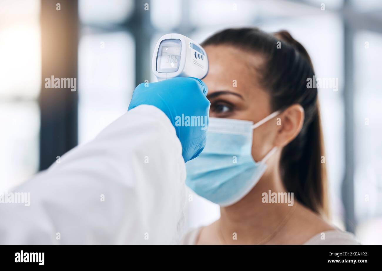 Covid, température et balayage de fièvre pour femme dans le cabinet de médecin pour la santé et le bien-être. Coronavirus, covid 19 et examen médical pour la femme en bonne santé dans un Banque D'Images