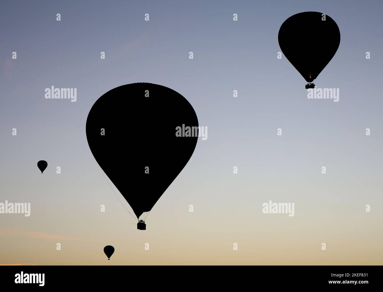 Les ballons à air chaud avec des silhouettes en Cappadoce, Turquie Banque D'Images