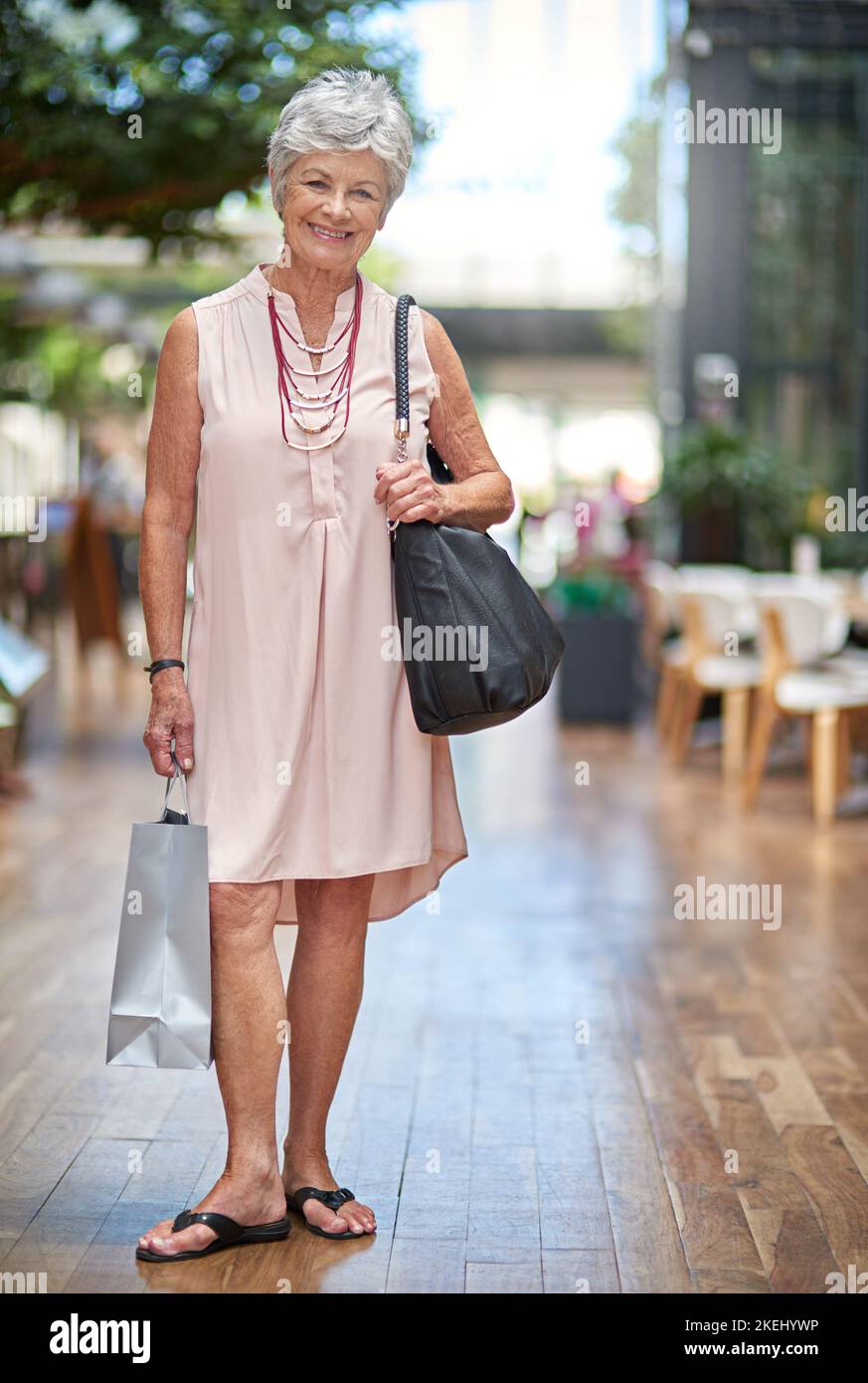 Il est temps de monter dans le centre commercial. Portrait complet d'une femme âgée sur une frénésie de shopping. Banque D'Images