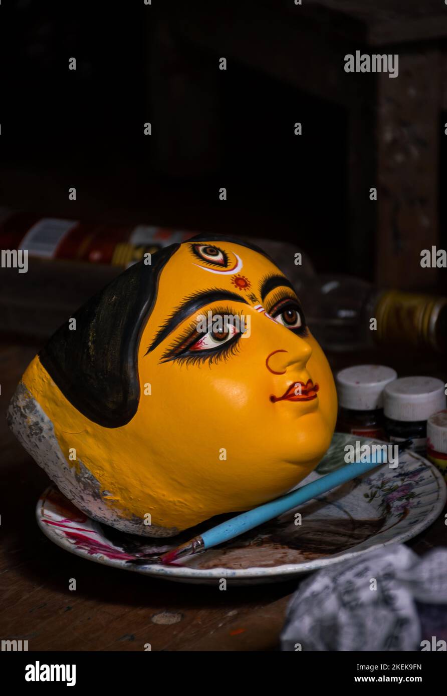 Face d'idole de la déesse Durga conservée sur plaque après peinture. Mise au point sélective sur l'idole avec d'autres flous. Banque D'Images