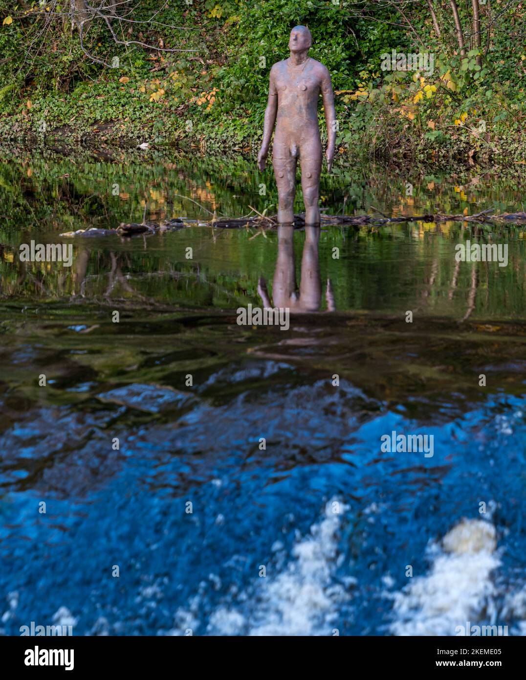 Anthony Gormley statue d'homme nu reflétée dans l'eau de la rivière Leith par le weir, Édimbourg, Écosse, Royaume-Uni Banque D'Images