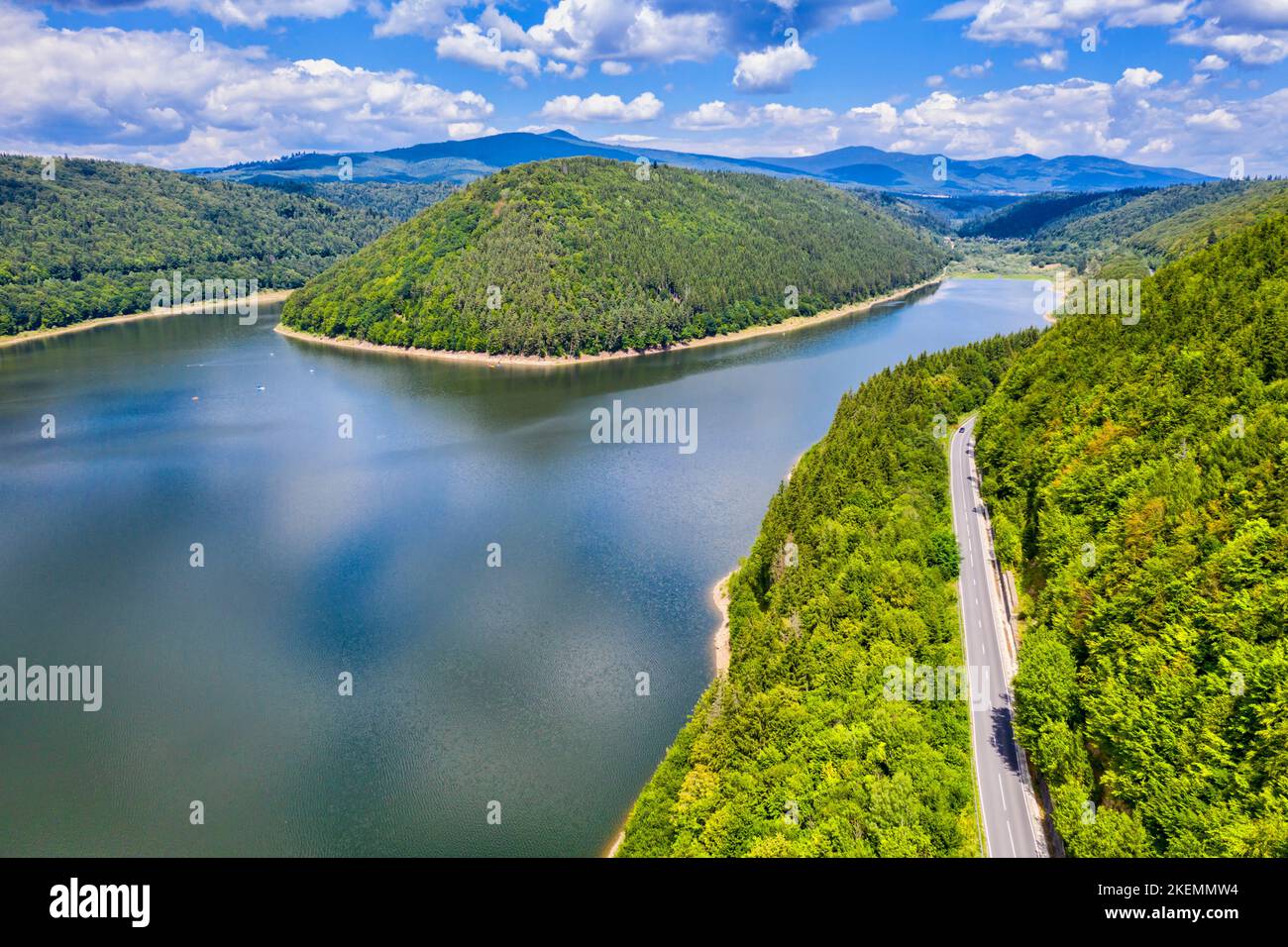 Vue aérienne de la route forestière près du lac, scène estivale dans les Carpates roumains. Banque D'Images