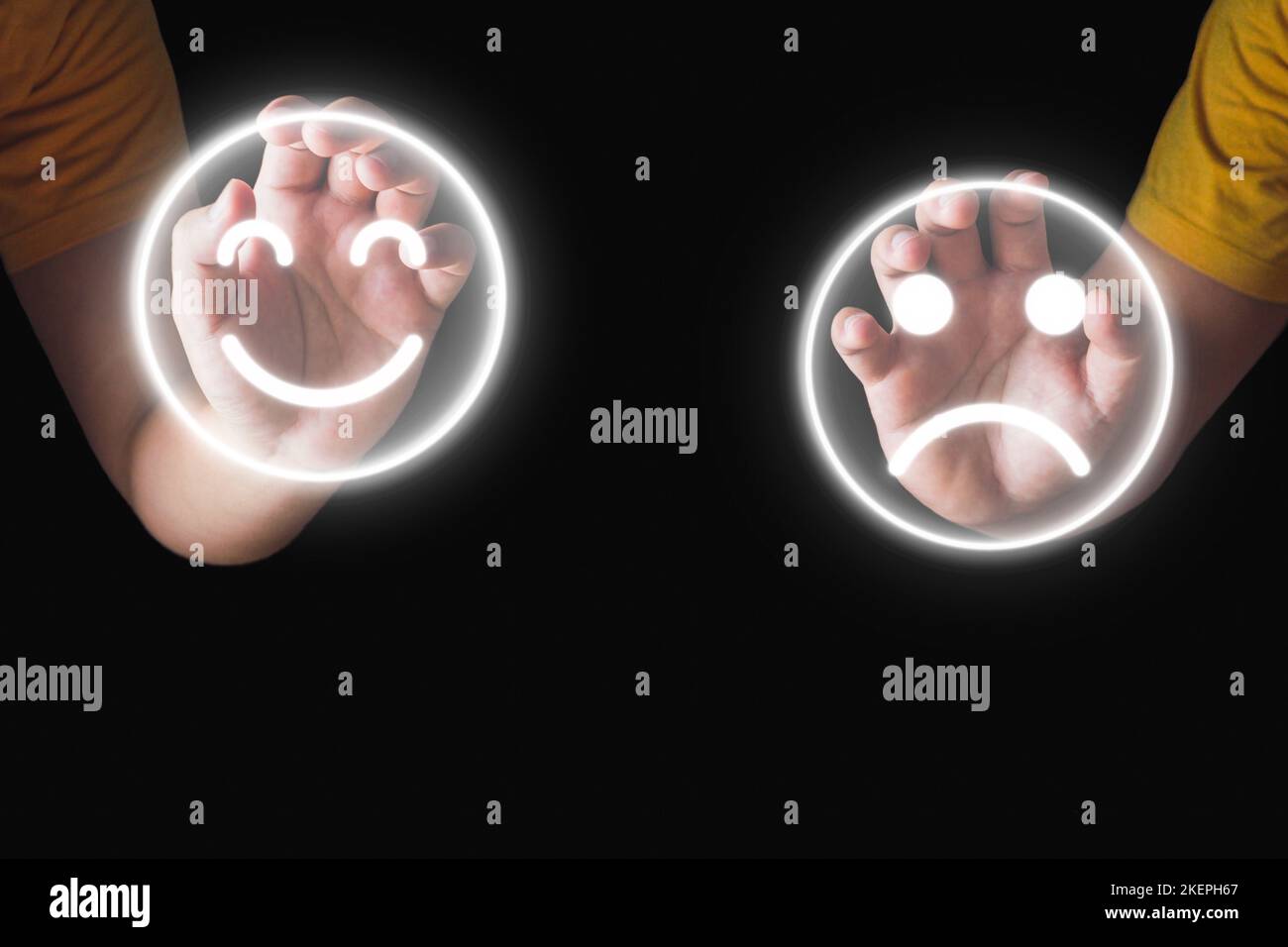 Évaluation et satisfaction. Les mains tiennent un sourire et un visage triste emoji. Concept de comparaison. Gros plan isolé sur fond noir. Banque D'Images