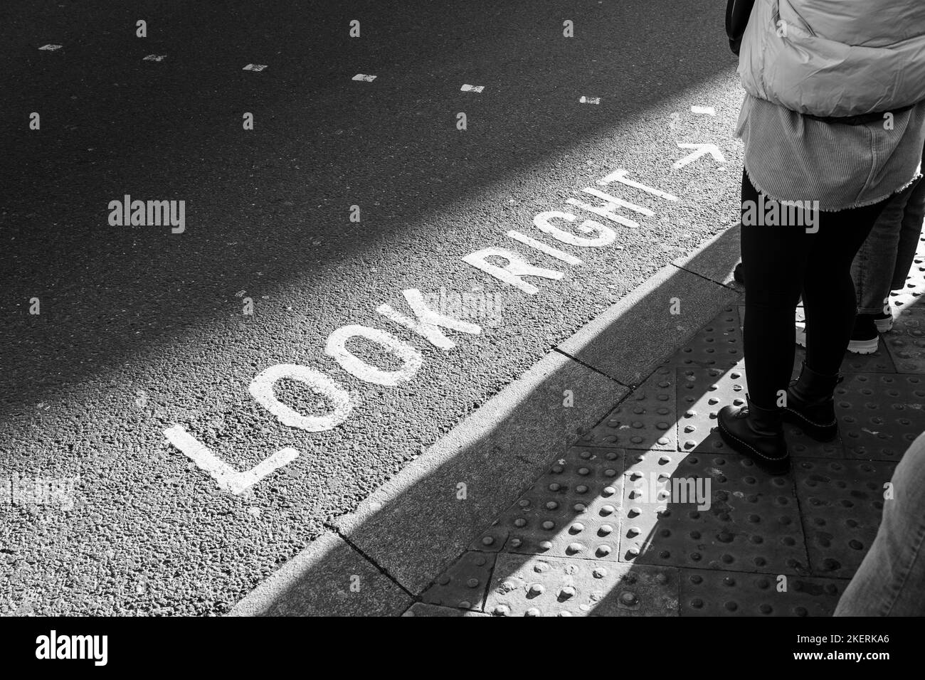 Marquage routier emblématique peint « look right » pour les piétons de Londres. Concept: Traverser la route, sécurité routière, piétons qui attendent, visiter Londres Banque D'Images