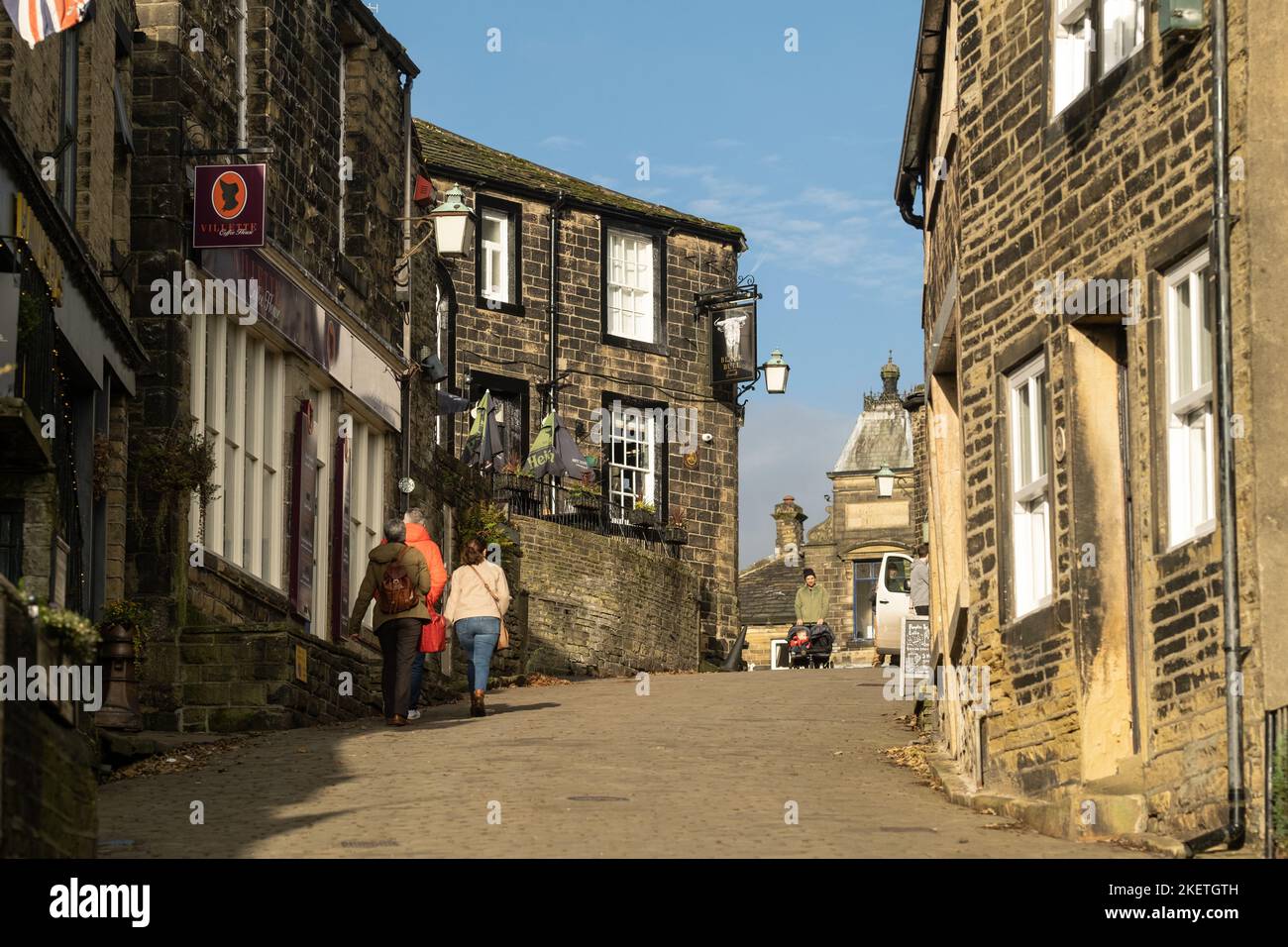 Haworth, West Yorkshire, Royaume-Uni. Marcher jusqu'au sommet de la rue principale pavée. Banque D'Images