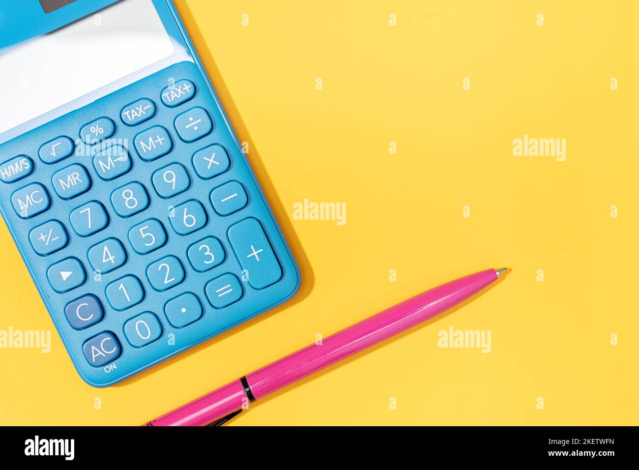 Mise à plat de la calculatrice et du stylet sur fond jaune. Couleurs vives espace de copie Banque D'Images