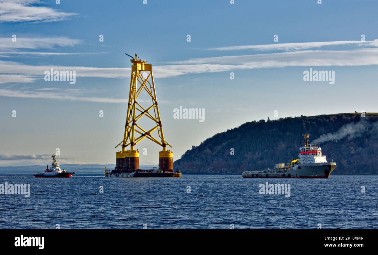 Cromarty Firth Nigg Scotland deux remorqueurs remorquant la base jaune d'une éolienne offshore dans le port Banque D'Images