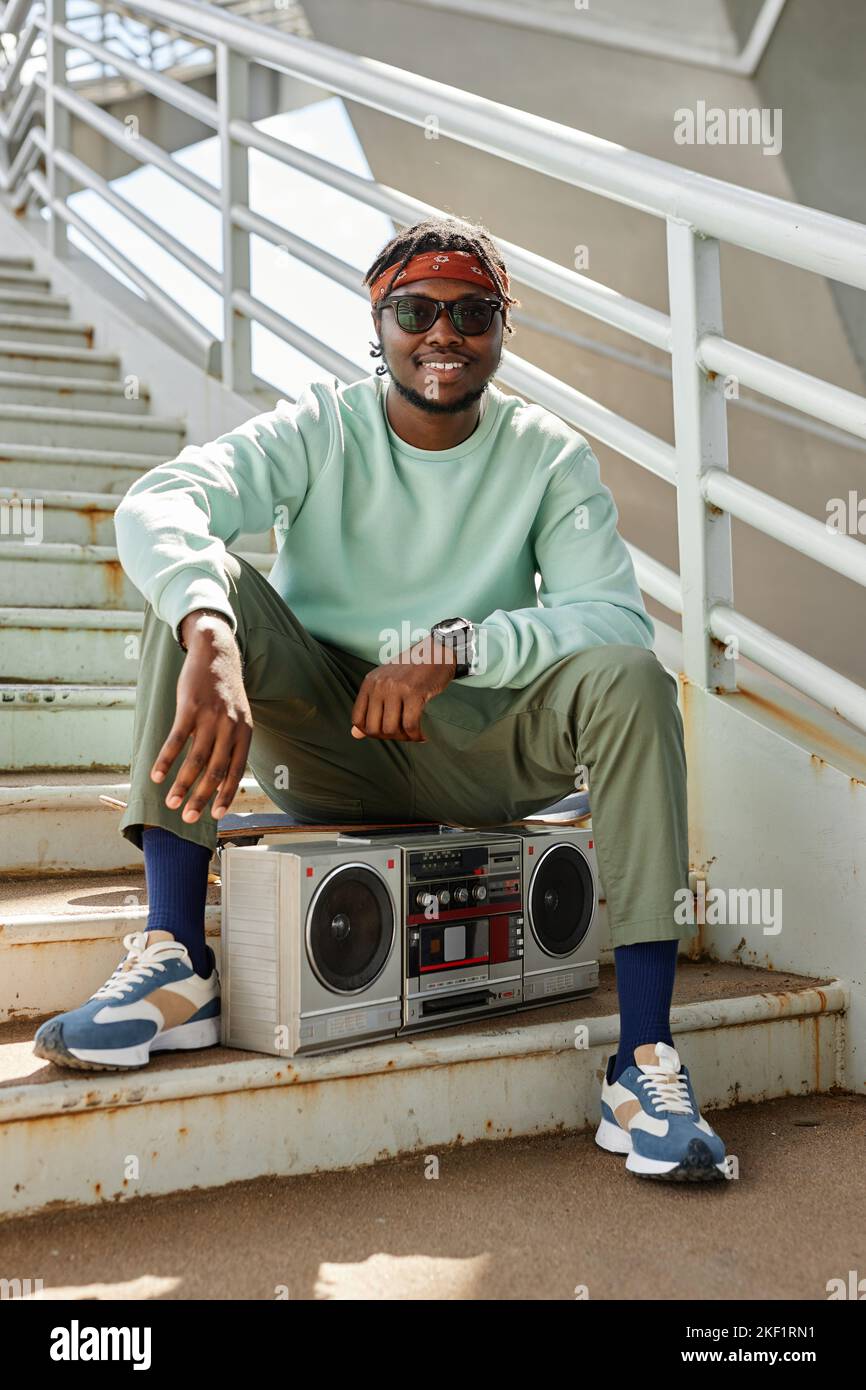 Portrait vertical d un jeune homme noir portant des vetements de style urbain posant a l exterieur avec une boombox Photo Stock Alamy