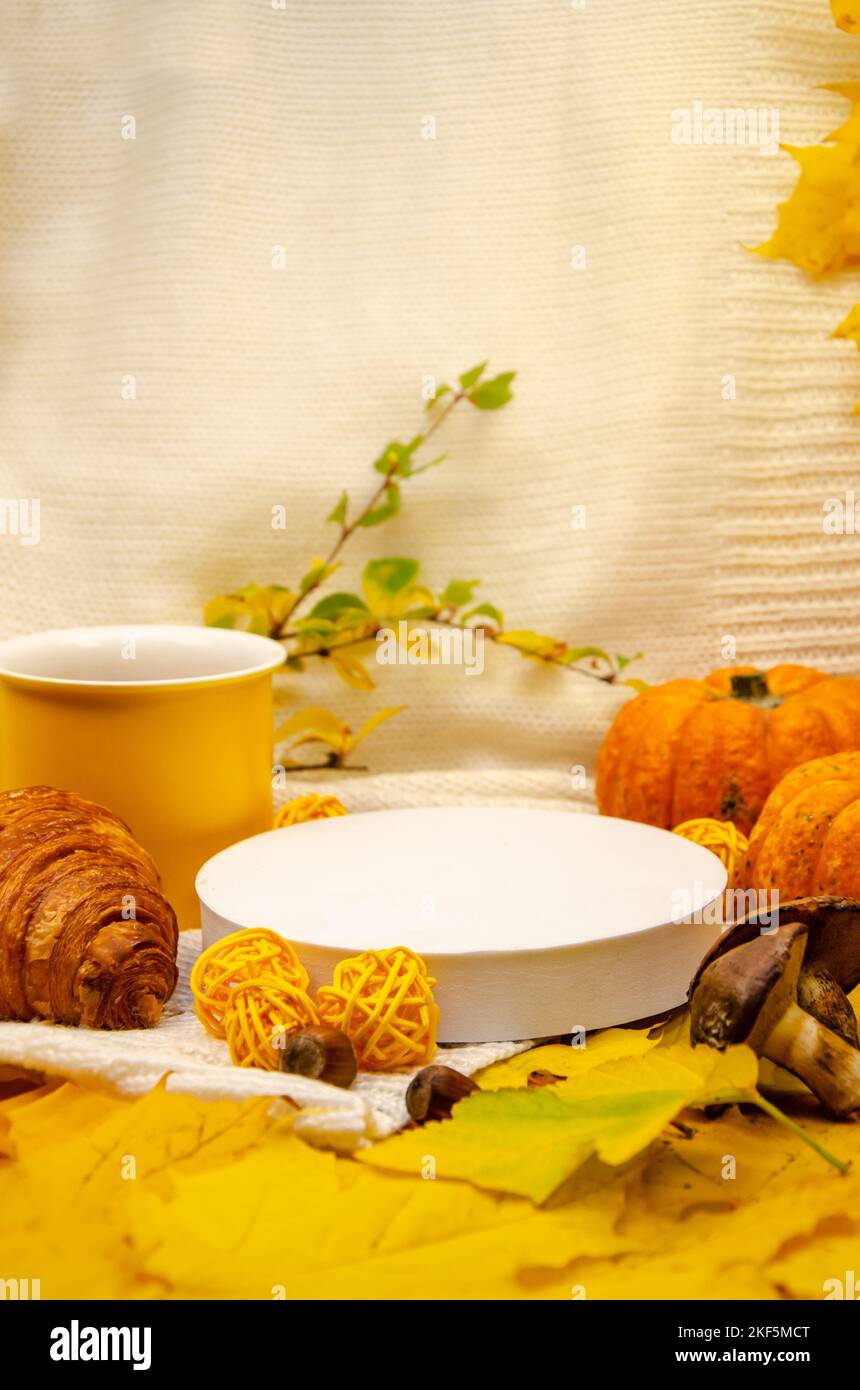 L'automne encore vie dans les tons jaune-orange: Un blanc tricoté plaid et des feuilles, gros plan vide podium scène blanche Banque D'Images