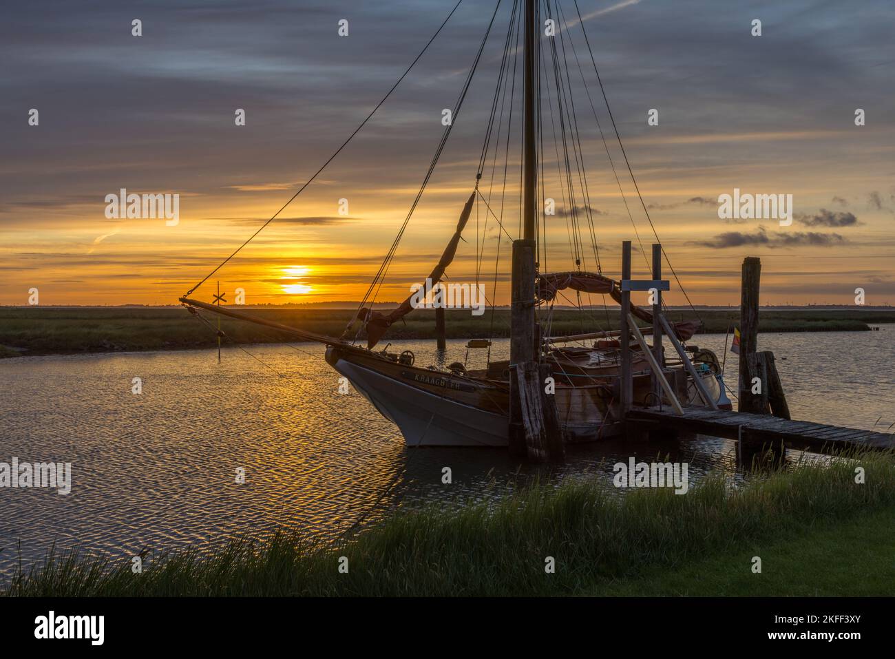 Sonnenaufgang mit Segelschiff am Süderhafen, Insel Nordstrand, Nordfriesland, Schleswig-Holstein, Allemagne Banque D'Images