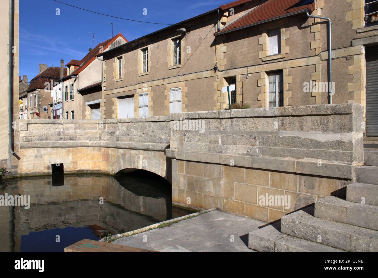 Vue pittoresque sur la rivière Nohain qui coule sous un pont dans le beau village de Donzy dans la Nièvre en France. Banque D'Images