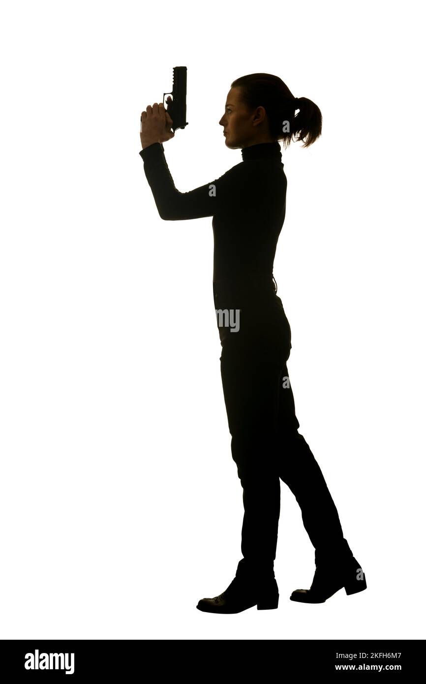 Demi-silhouette d'une femme tenant un fusil Banque D'Images