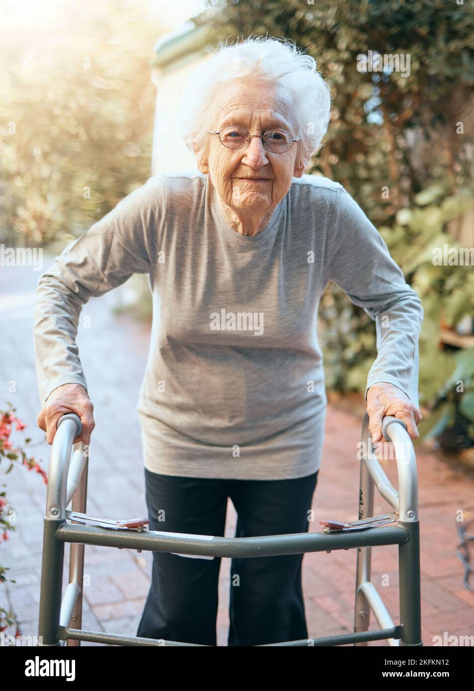 Portrait, vieille femme et cadre de marche au parc pour les soins de santé, le bien-être et un soleil sain. Liberté, retraite et femmes âgées handicapées Banque D'Images