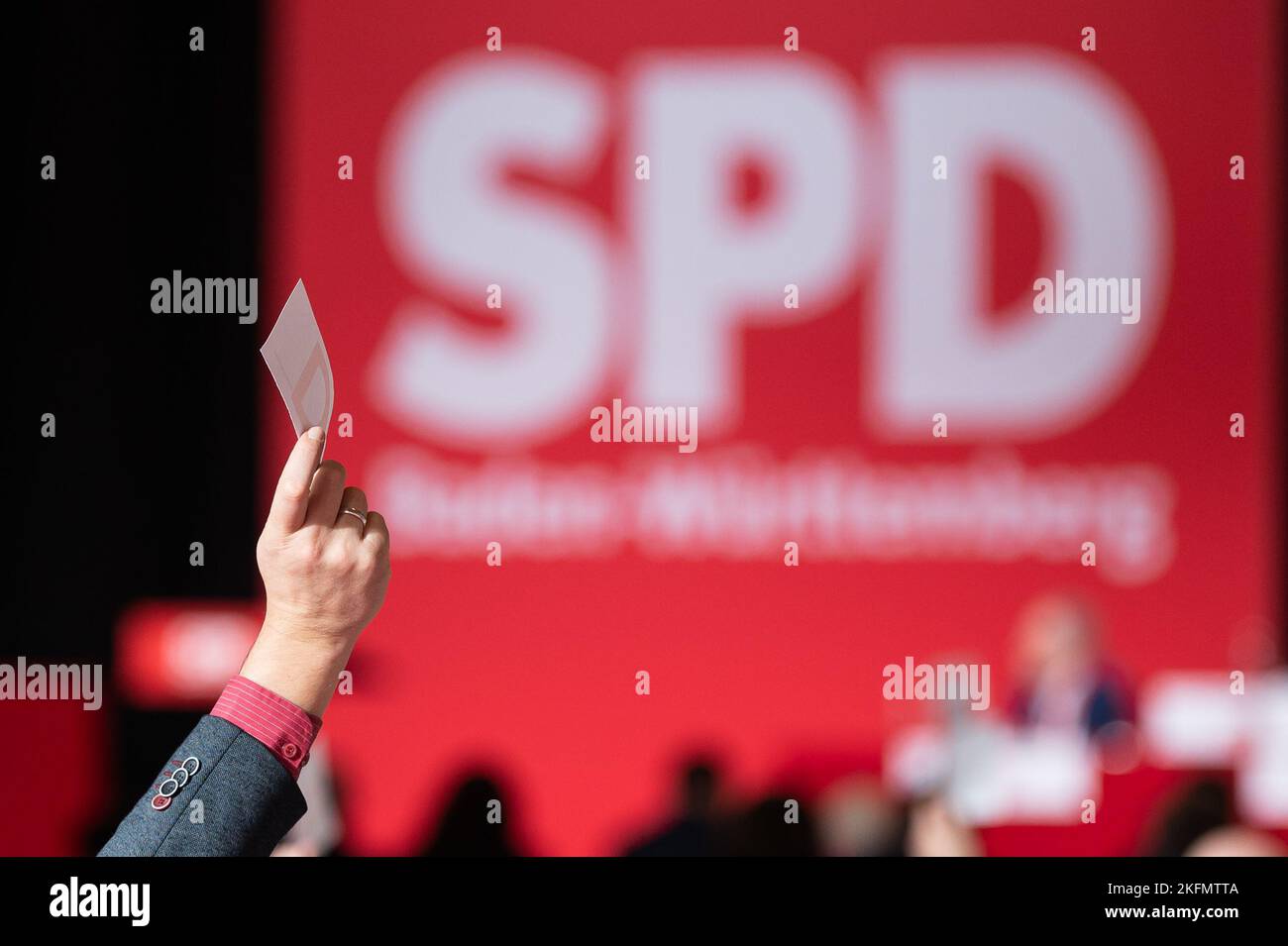 Friedrichshafen, Allemagne. 19th novembre 2022. Un membre du parti du SPD tient une carte de vote à la conférence du parti d'Etat du SPD Baden-Württemberg lors de la détermination des points de l'ordre du jour. Le logo SPD est visible en arrière-plan. Lors du congrès du parti, la direction du SPD d'État est nouvellement élue. Crédit : Silas Stein/dpa/Alay Live News Banque D'Images