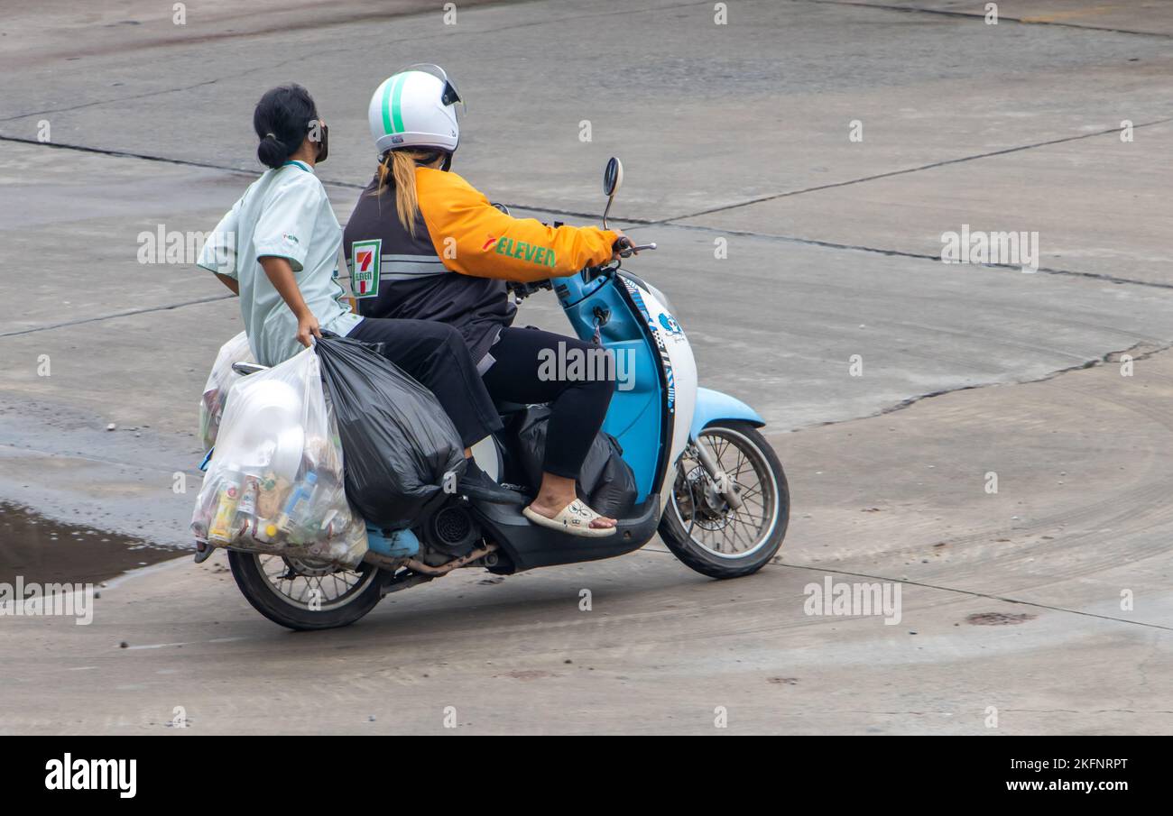 SAMUT PRAKAN, THAÏLANDE, SEP 26 2022, Un employé de supermarché emportant les déchets dans des sacs en plastique sur une moto Banque D'Images