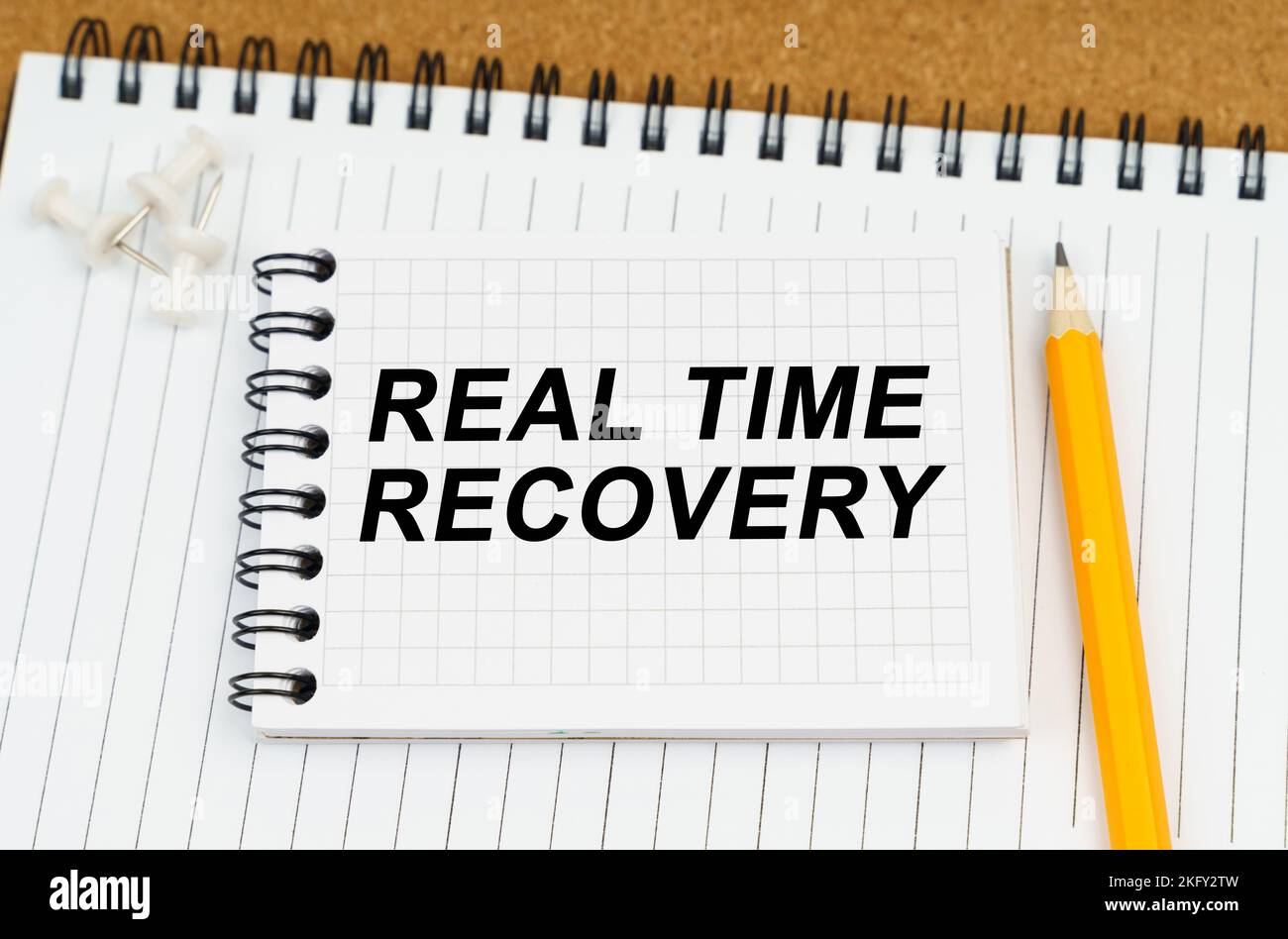 Concept d'affaires et d'économie. Il y a deux carnets et un crayon sur la table. Sur le bloc-notes supérieur, l'inscription - Real Time Recovery Banque D'Images