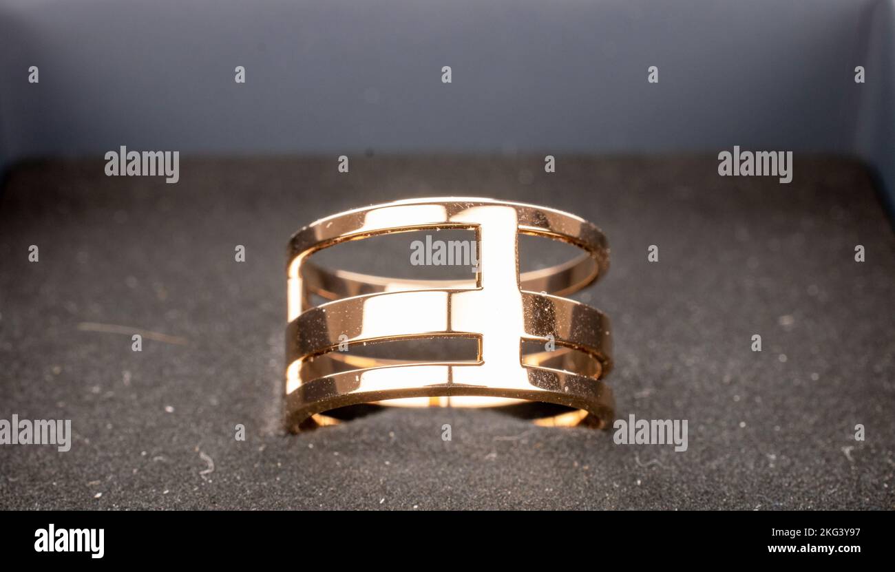 Un anneau doré dans une boîte en papier décorative, macro. Banque D'Images
