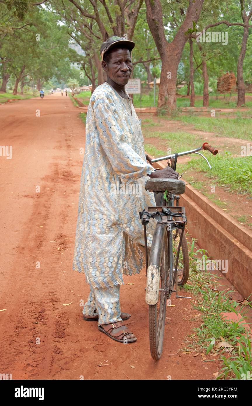 Homme à vélo portant une robe africaine, Tangueta, Atacora, Bénin Banque D'Images