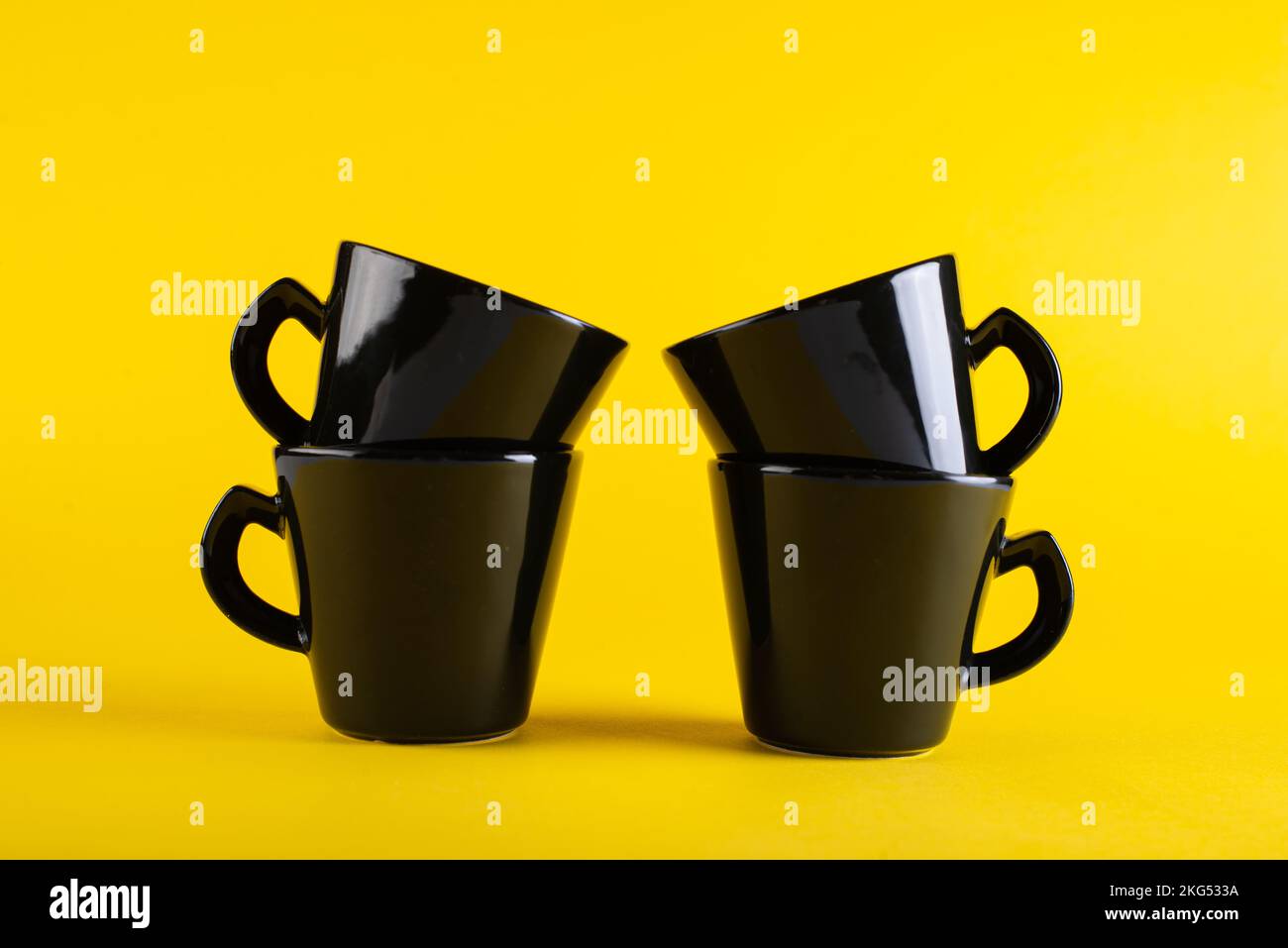 Les tasses sont noires sur fond jaune vif pour les clients Banque D'Images