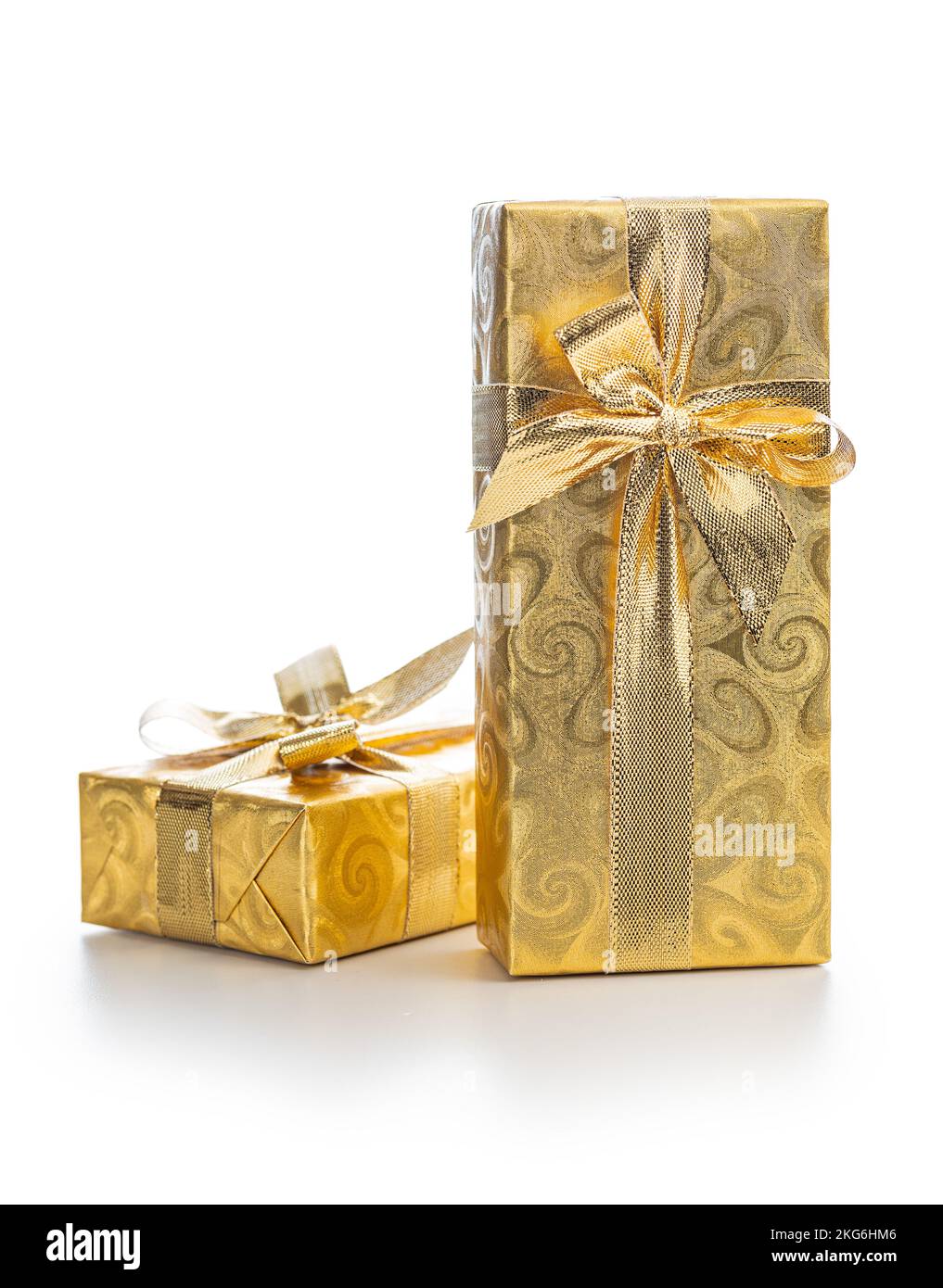 Cadeau emballé dans du papier d'aluminium doré. Cadeau de Noël avec ruban d'or isolé sur fond blanc. Banque D'Images